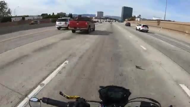 Un motard aide un automobiliste en panne sur l'autoroute