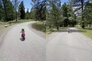 Un père aide sa fille, qui s'est lancée trop vite en vélo, à garder son calme