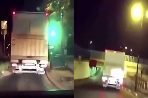 Il filme un camion pour voir si il va réussir à passer sous un pont (France)