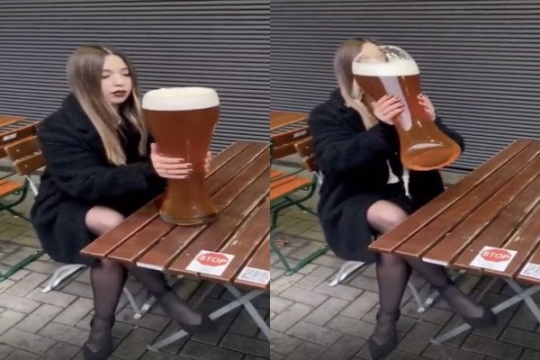 Une fille boit une énorme bière